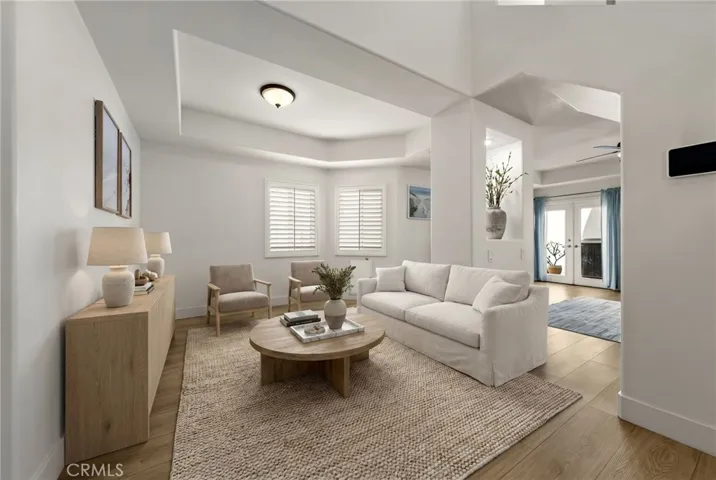 Versatile additional living space upon entry, ideal for a sitting area or lounge (Virtual staging)