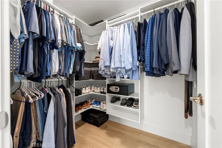 Well-appointed walk-in closet with custom built-in storage