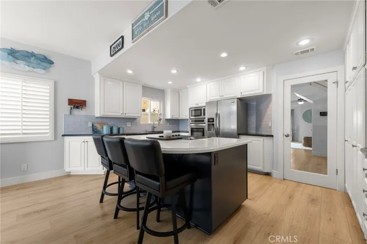 Expansive kitchen island with quartz countertops, ideal for entertaining and everyday living