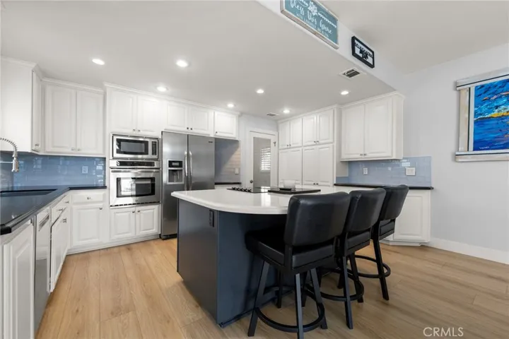 Large kitchen island with quartz countertops and seating space