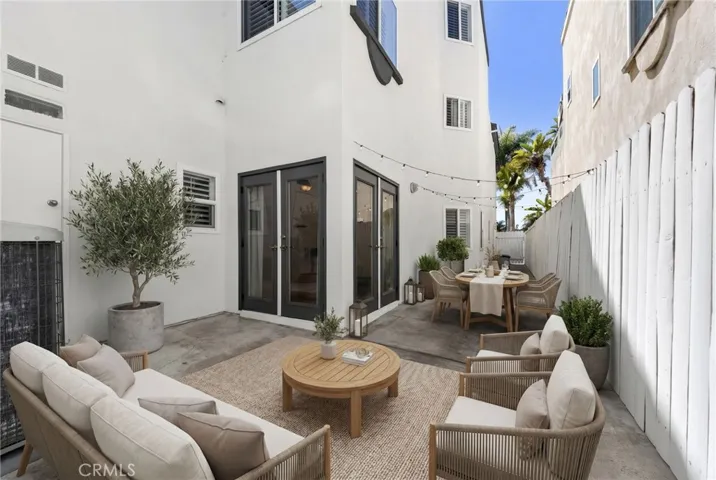 Secluded side yard adjacent to the den and family room, creating an ideal space for outdoor dining and relaxed coastal living (virtual staging)