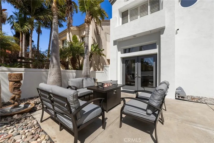 Private front courtyard patio featuring a firepit and lounge seating, perfect for entertaining