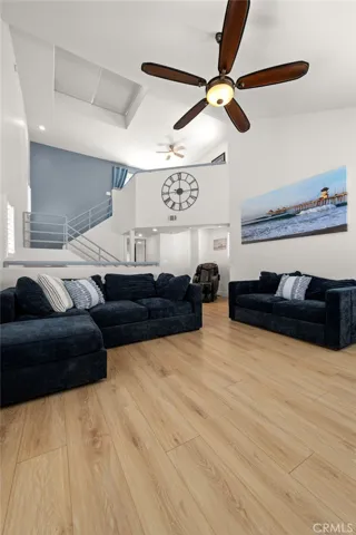 Open view of the great room with staircase leading to the third-story loft and rooftop deck