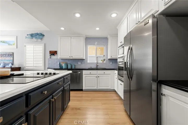 Remodeled kitchen featuring a spacious island and stainless steel appliances
