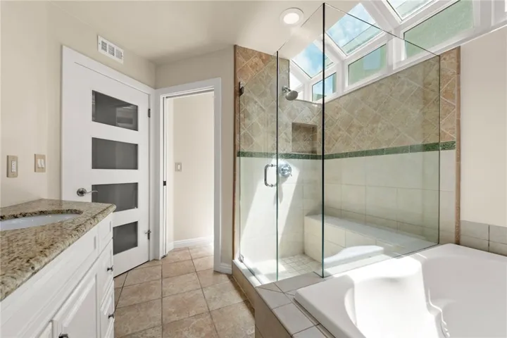 Private primary retreat featuring a massive walk-in shower and a tranquil, secluded feel