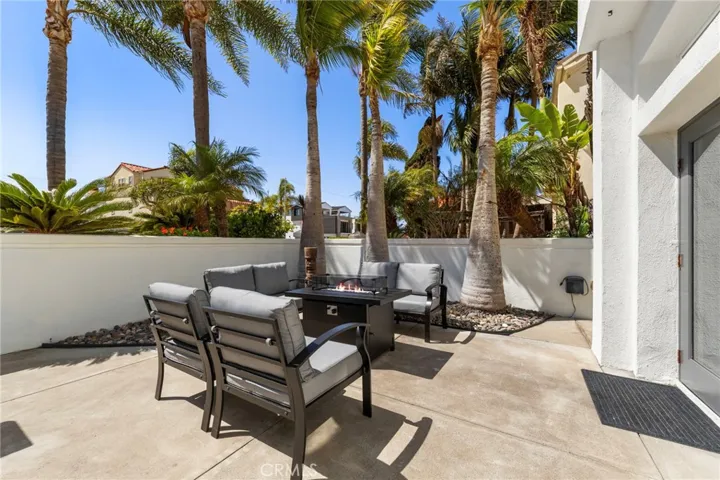 Inviting front courtyard patio with firepit and comfortable seating for outdoor living