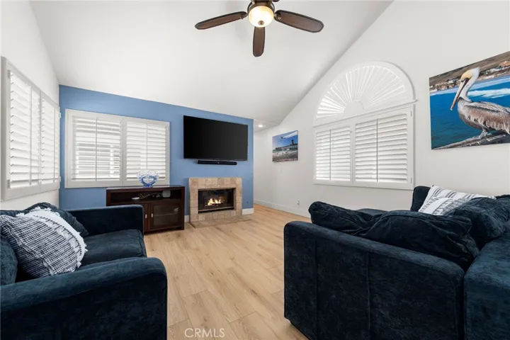Light-filled upstairs great room with soaring vaulted ceilings and a fireplace, ideal for relaxing or entertaining