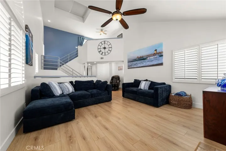 Spacious upstairs great room featuring vaulted ceilings and a fireplace