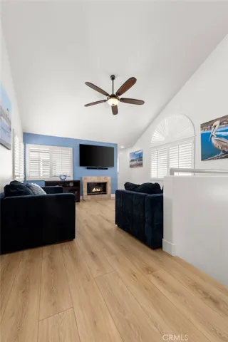 Warm and inviting second-level great room with soaring vaulted ceilings, abundant natural light, and an ideal setting for family gatherings or guest retreats