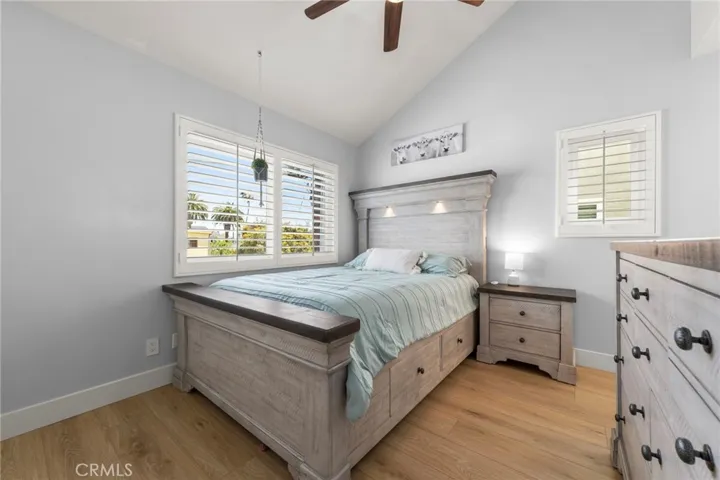 Secondary en-suite bedroom with vaulted ceilings and abundant natural light