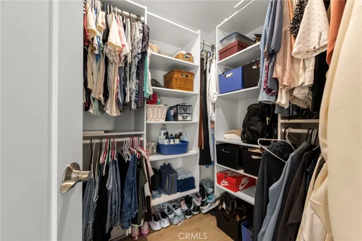 Expansive walk-in closet featuring custom built-in organization and storage solutions
