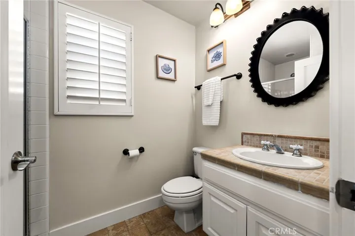 Bright and well-appointed second-story hall bathroom serving the secondary bedrooms