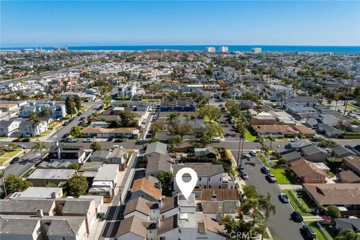 Aerial southwest-facing view of the home highlighting its close proximity to the ocean and coastal setting