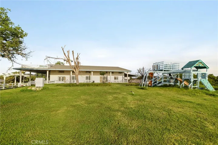 View of primary residence and adjoining yard space