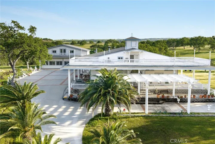 Aerial view of the primary residence with large view decking, garage building in back to the left