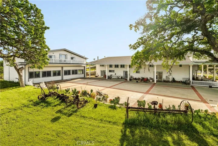 Entry driveway and parking, main residence on right, garage building on left