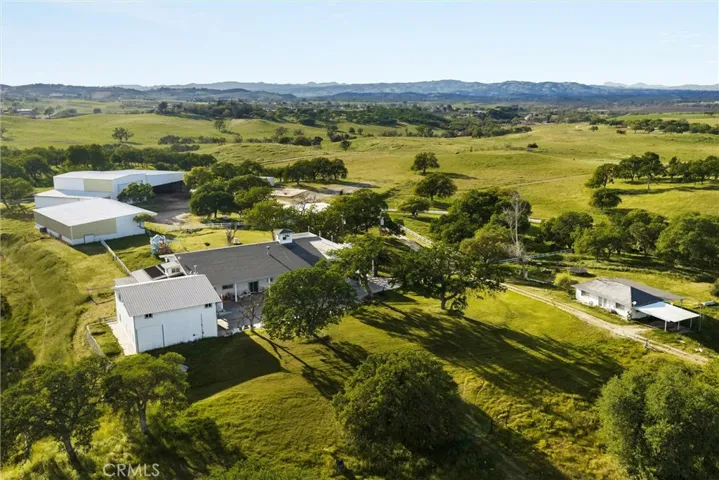 Aerial view of residences and structures, looking to the west