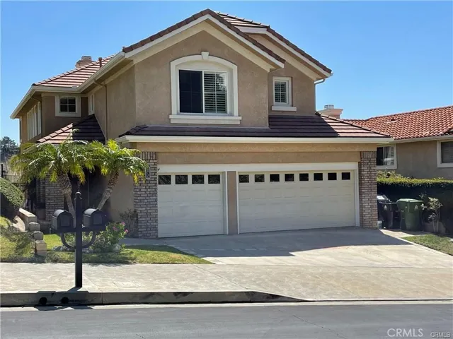 Front view with three car garage
