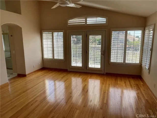 Master bedroom with high ceilings and access to balcony