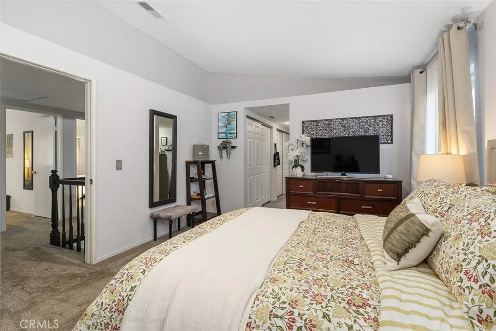 The primary bedroom is a peaceful retreat with abundant storage.