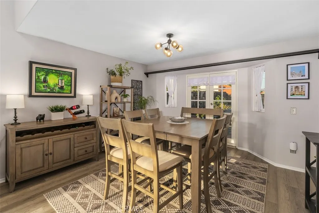 Dining area boasts double French doors and two pretty windows.