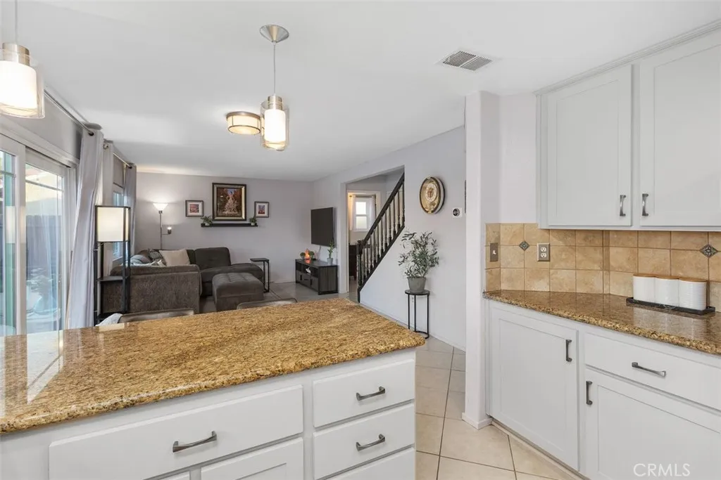 Beautifully resurfaced cabinets and warm granite counters show nicely.