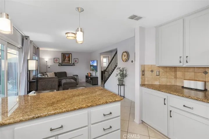 Beautifully resurfaced cabinets and warm granite counters show nicely.