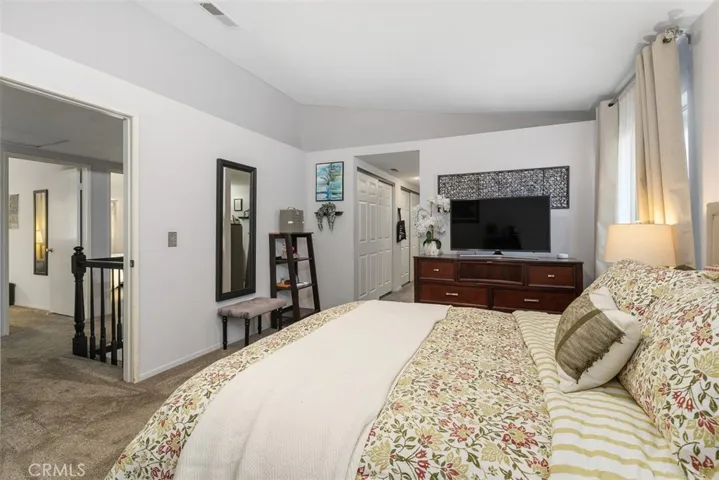 The primary bedroom is a peaceful retreat with abundant storage.
