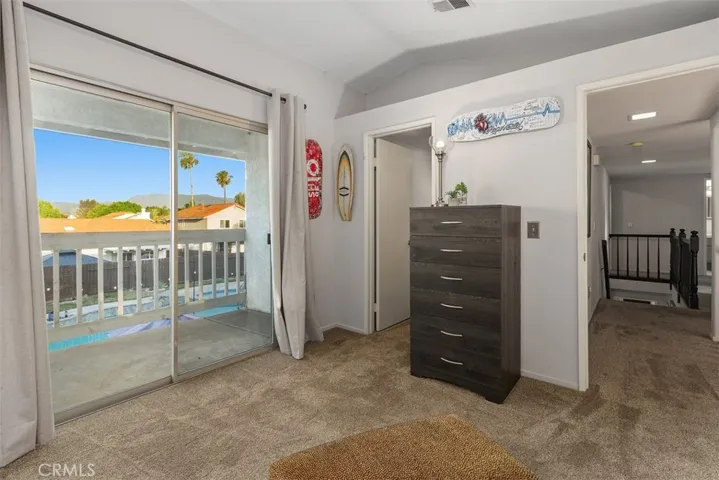 Bonus loft off of primary suite has two balconies: one overlooking the living room and another above the gorgeous backyard.