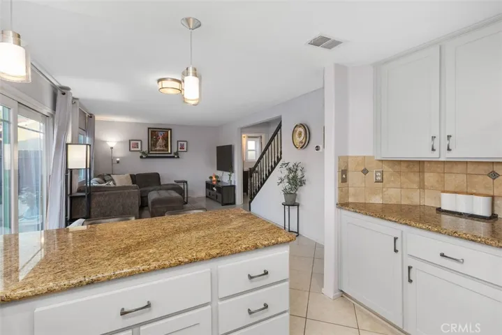 Beautifully resurfaced cabinets and warm granite counters show nicely.