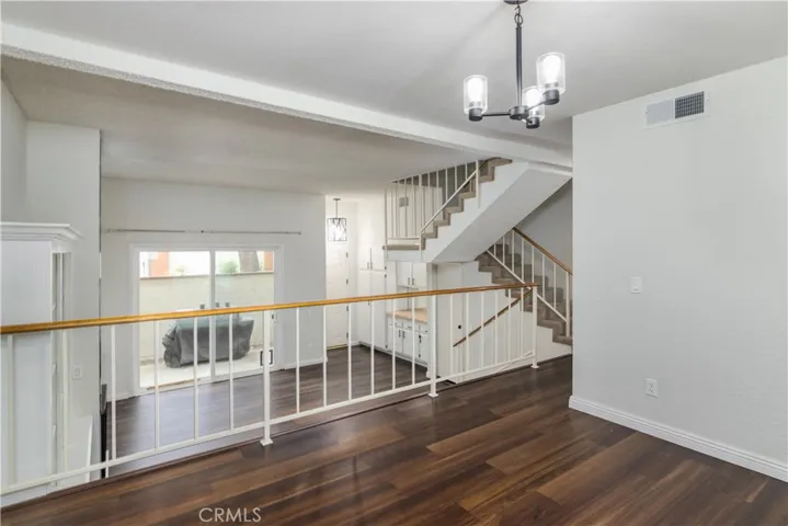 View from the dining area to the living room and the entry and outside patio.