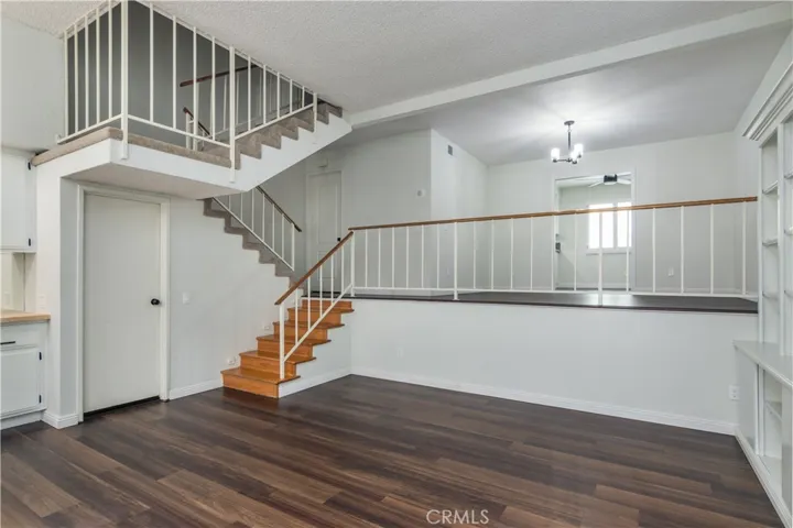 Another view from the front slider area looking into the living room and dining area. door to the left of stairs leads to 2 car garage below the townhome.
