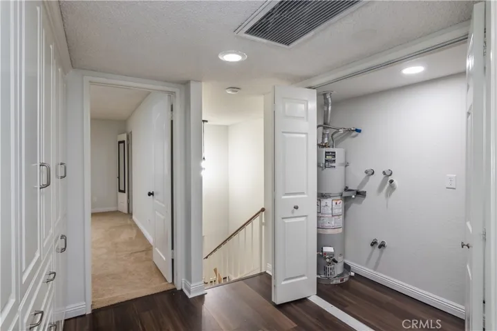 Upstairs landing where there is a waher/dryer hookups in a closet and a linnen closet on the opposite side.