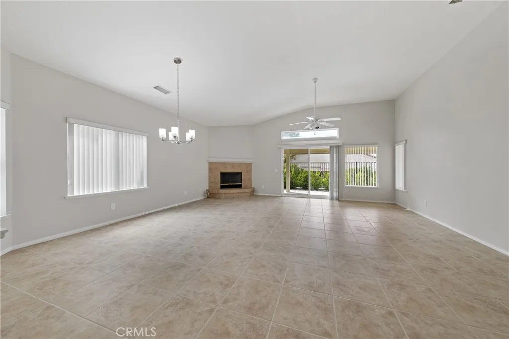Great room for living and dining has tile flooring, a fireplace and opens to your patio.