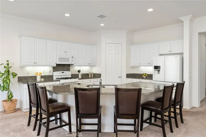 Ample seating around granite kitchen island