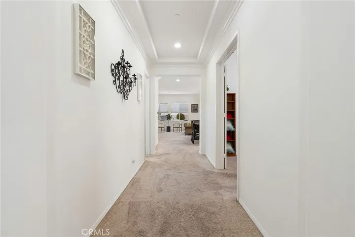 View from front entry into wide hallway. To the immediate right is the guest bedroom, then in the middle hallway to the right is the Den or third bedroom