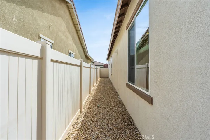 Side view is kept clean alongside vinyl fencing.