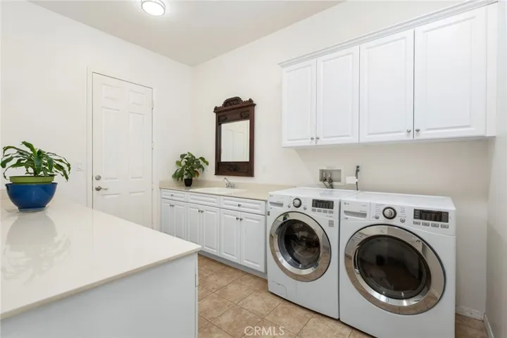 The laundry room is located to the left side upon front entry with its own separate room with a door, and another door leading to garage.