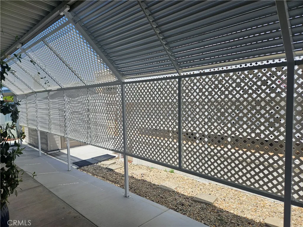 Extended carport with privacy screens