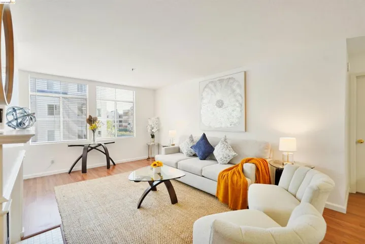Living area featuring wood-finish flooring, white walls, and white ceiling