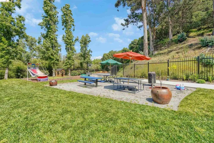 Expansive grassy area with a dedicated gravel-covered recreational space