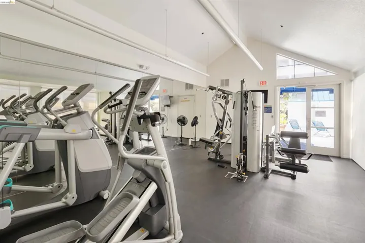 Fitness center featuring rubberized flooring and mirrored walls