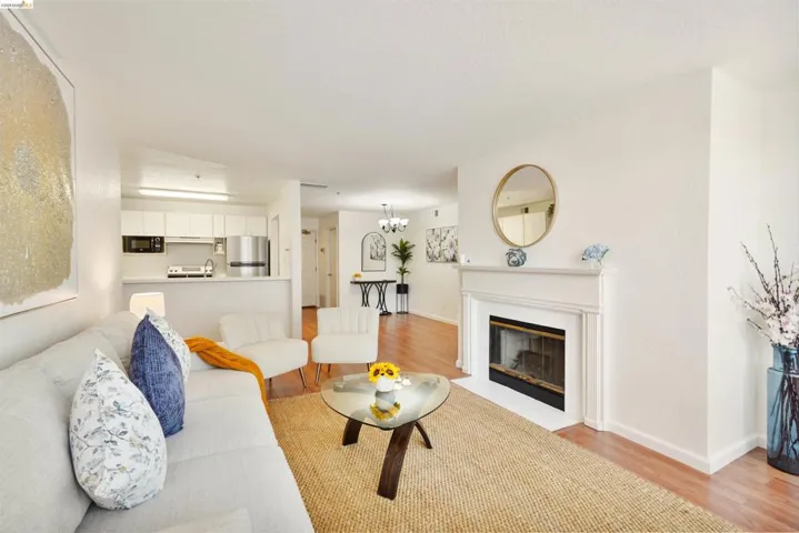 Living area featuring wood-finish flooring and a decorative fireplace with a classic mantel