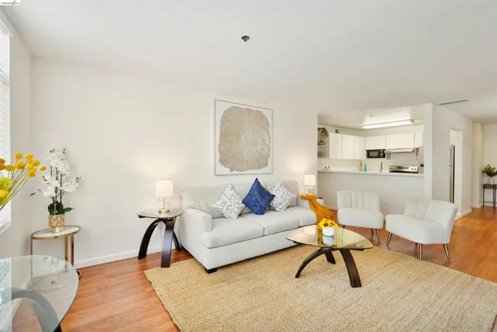 Open concept living area with wood-finish flooring
