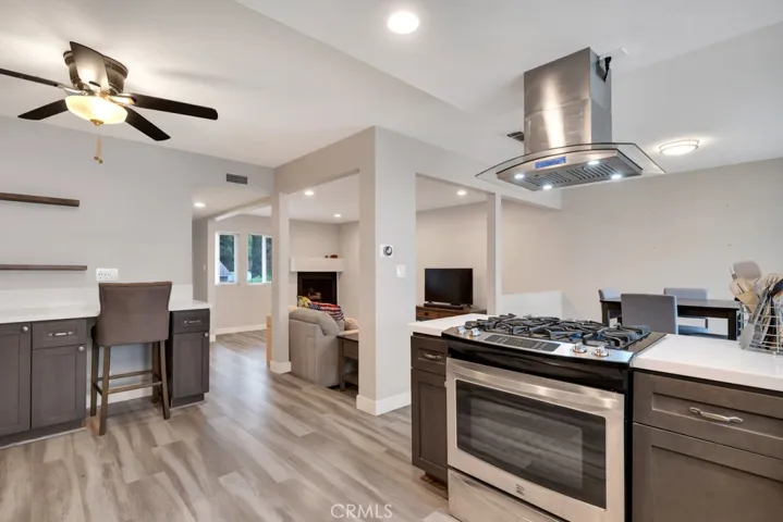 Kitchen with quartz counters, stainless steel appliances and recessed lights