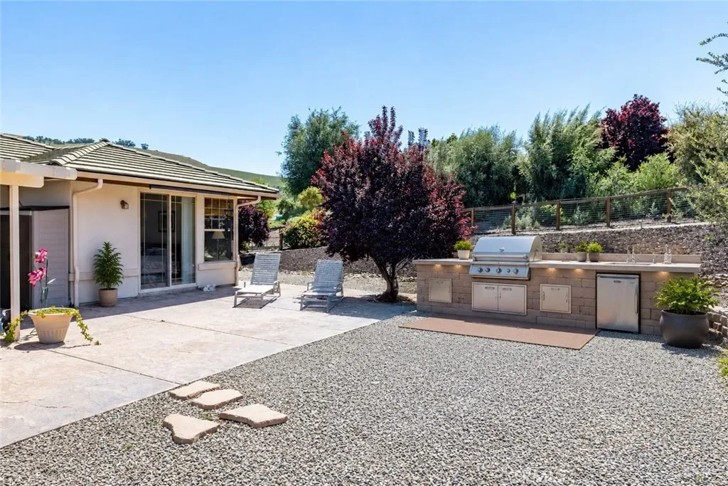 This is an AI generated photo to show how simple it would be to add an outdoor kitchen just off the patio area.
