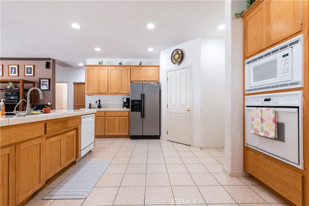 Massive sized kitchen. Door you see is walk in pantry. On the right side is hallway to garage. The door you see is walk in pantry
