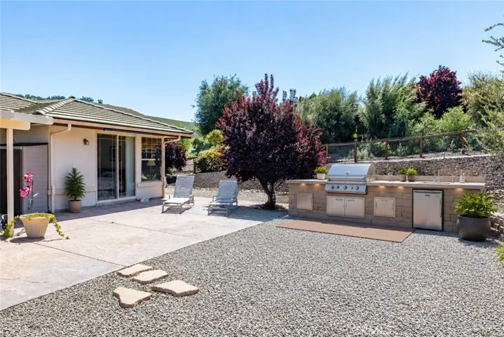 This is an AI generated photo to show how simple it would be to add an outdoor kitchen just off the patio area.
