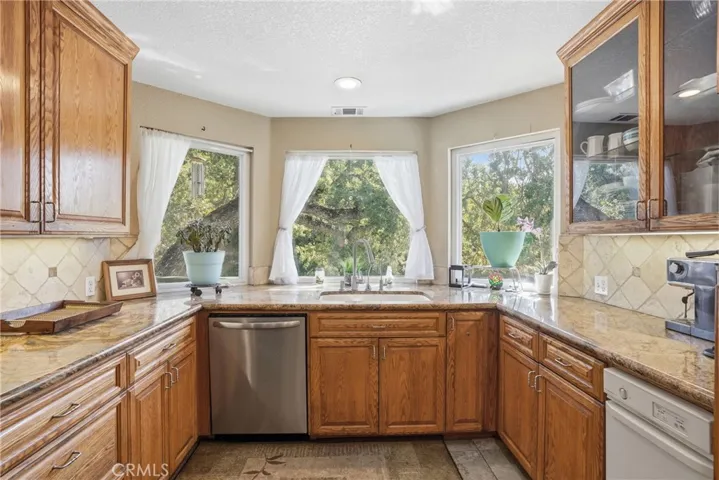 Street/tree view from sink. Ample kitchen natural light