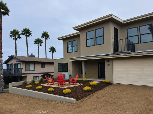 Front Vista duplex. Awaiting concrete garage, sidewalk and black rail fencing on top of retaining walls.